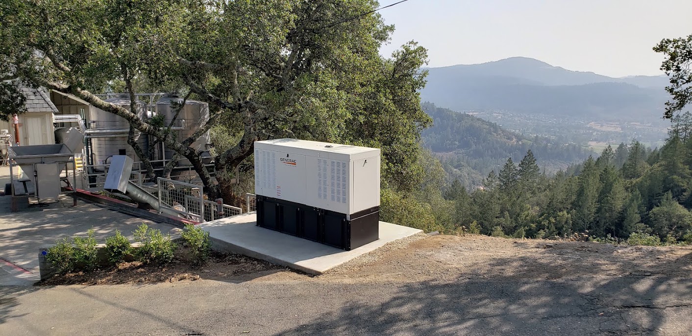 Standby generator installed beside a hillside property