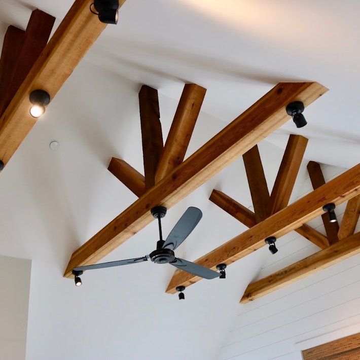Custom interior lighting installed on exposed wood beams