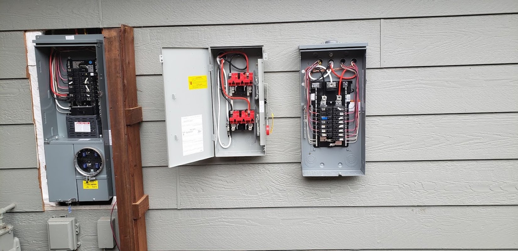Open residential electrical panels prepared for a panel upgrade in Windsor